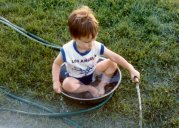 A boy, a hose, and a hot afternoon